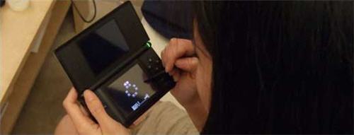 Picture of woman playing Bejeweled on her Nintendo DS